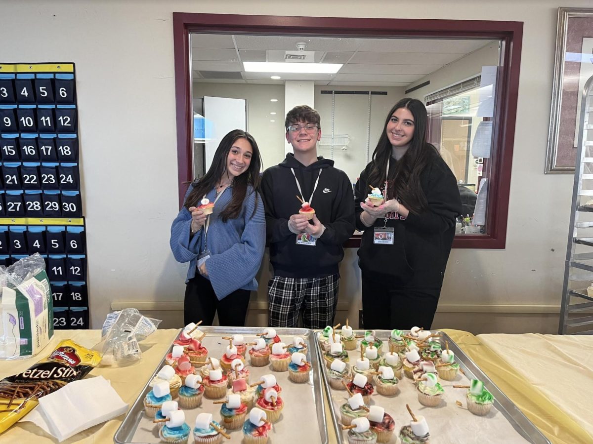 Students participated in many activities such as cupcake decorating (top) and magnet making at the third annual Comic-Con on Feb. 7 in the high school library.